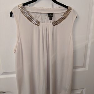 Cream tank top with gold sequence embelishments.